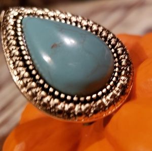 A beautiful gold and turquoise teardrop ring